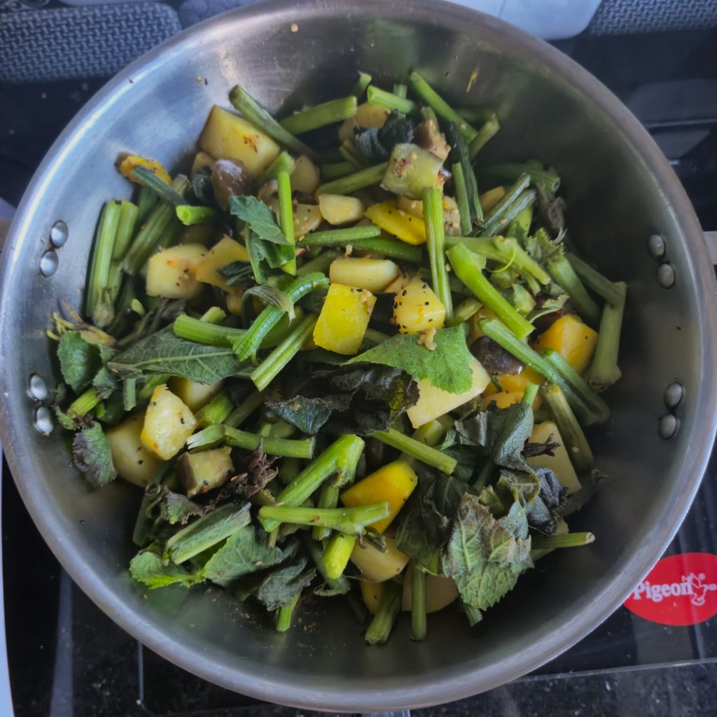 Adding pumpkin greens to the veggie mixture